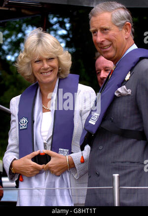 The Prince of Wales and the Duchess of Cornwall cruise on a solar powered boat on Barton Broad, as part of National Parks Week. The royal couple took a trip on the solar boat 'Ra', Britain's only passenger carrying solar powered boat. The non-polluting boat is named after the Egyptian sun god and was commissioned in 2000 as part of the Authority's Clear Water 2000 Millennium Project which restored the water quality and depth of Barton Broad. Stock Photo