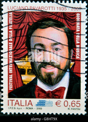 ITALY - CIRCA 2009: A stamp printed in Italy shows Luciano Pavarotti, famous tenor, circa 2009 Stock Photo