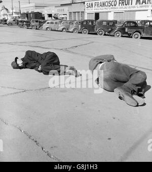 Two Men Sleeping on Sidewalk of 'Skid Row', Howard Street, San Francisco, California, USA, Dorothea Lange for Farm Security Administration, February 1937 Stock Photo