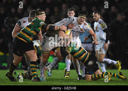 Exeter Chiefs' Thomas Waldrom (centre) is tackled by Northampton Saints' Paul Hill (left) and JJ Hanrahan (right) during the Aviva Premiership match at Franklin's Gardens, Northampton.