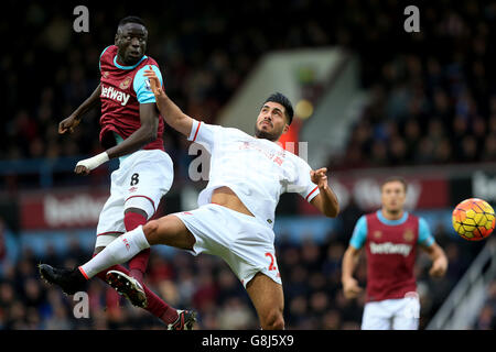 West Ham United's Cheikhou Kouyate (left) and Liverpool's Emre Can battle for the ball during the Barclays Premier League match at Upton Park, London. Stock Photo