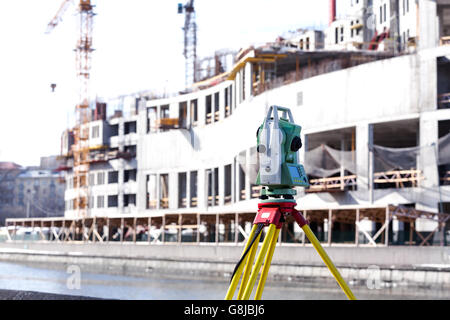 Total station (land-surveying instrument) mounted on tripod Stock Photo