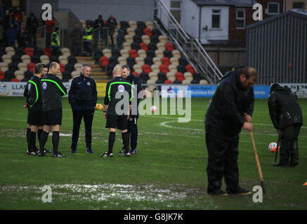 Blackburn Rovers Manager Paul Lambert with Newport County Manager John Sheridan discuss game with referee Charles Breakspear as the match off due to waterlogged pitch, during the Emirates FA Cup, third round game at Rodney Parade, Newport. Stock Photo