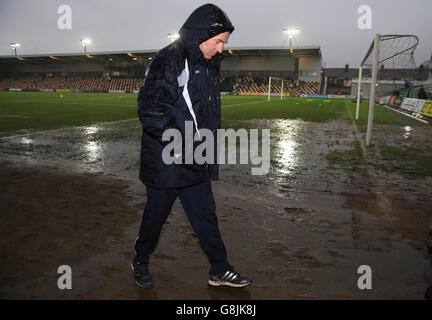 Newport County manager John Sheridan walks off the pitch after referee Charles Breakspear calls the match off due to waterlogged pitch, during the Emirates FA Cup, third round game at Rodney Parade, Newport. Stock Photo