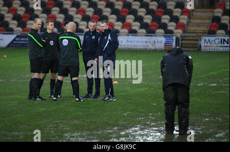 Blackburn Rovers manager Paul Lambert and Newport County manager John Sheridan (right) with the match officials after referee Charles Breakspear calls the match off due to a waterlogged pitch, during the Emirates FA Cup, third round game at Rodney Parade, Newport. Stock Photo