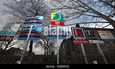 Estate agents' boards are displayed outside flats on Poynders Road, south London. Stock Photo