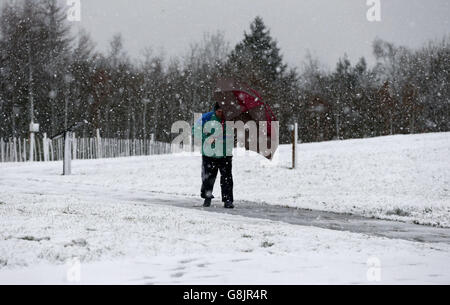 A man walks through the snow close to the Angel of the North in Gateshead, Tyne and Wear, as the UK braced for a new wave of bad weather after forecasters issued warnings of heavy snow in parts of England and Scotland. Stock Photo