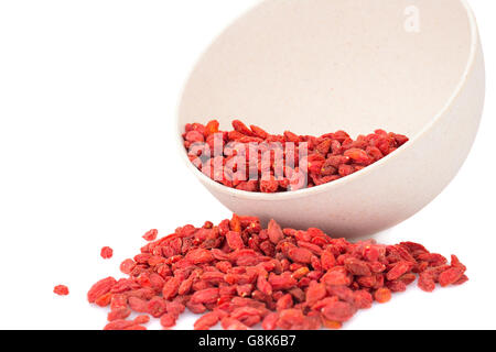 Goji berries in bamboo bowl on white background. Stock Photo