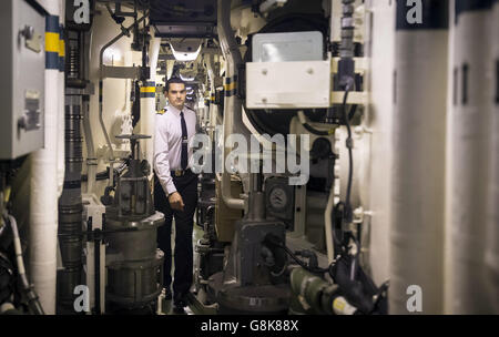 Strategic Missile Officer Lt Benson, in the missiles compartment that can house up to 16 Trident 2 D5 nuclear missiles, on board Vanguard-class submarine HMS Vigilant, one of the UK's four nuclear warhead-carrying submarines, at HM Naval Base Clyde, also known as Faslane, ahead of a visit by Defence Secretary Michael Fallon. Stock Photo