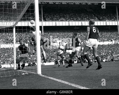 Goalkeeper Ferguson and Spurs' centre-forward Saul are in a mid air duel. West Ham players around are, left to right; Right-back Bonds, left-back Charles, centre-half Cushley and left-half and captain Bobby Moore (No.6). Also seen, in white shirts, are Spurs' inside-right Jimmy Greaves (centre background) and outside-left Jones (partly hidden second from right). Stock Photo