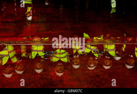 The reflection of Royal Navy crew members during a tour of the Royal Navy's second flagship aircraft carrier, HMS Prince of Wales is currently being assembled at the Rosyth dockyard in Fife and is expected to begin sea trials in 2019. Stock Photo