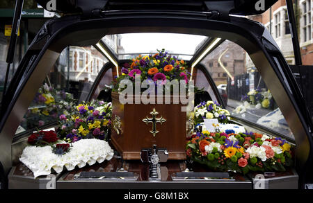 Floral tributes and messages lie next to the coffin of DJ Ed 'Stewpot' Stewart, as the funeral of the former disc jockey and TV presenter takes place at St Peter's Church in Bournemouth. Stock Photo
