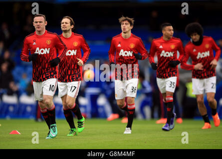 Manchester United's Wayne Rooney (left) warms up before the Barclays Premier League match at Stamford Bridge, London. Stock Photo