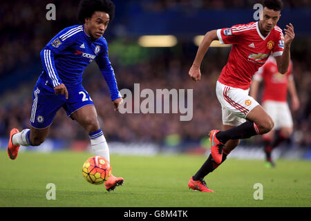 Chelsea's Willian (left) and Manchester United's Cameron Borthwick-Jackson during the Barclays Premier League match at Stamford Bridge, London. Stock Photo