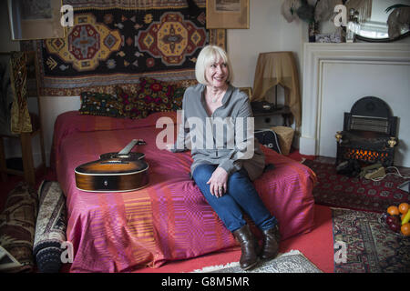 Jimi Hendrix's former girlfriend Kathy Etchingham poses on the musician's bed during the press preview of the new heritage site celebrating Jimi Hendrix at the flat he lived in between 1968 and 1969 on Brook Street, London. Stock Photo