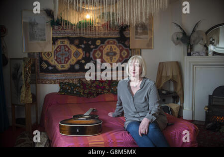 Jimi Hendrix's former girlfriend Kathy Etchingham poses on the musician's bed during the press preview of the new heritage site celebrating Jimi Hendrix at the flat he lived in between 1968 and 1969 on Brook Street, London. Stock Photo