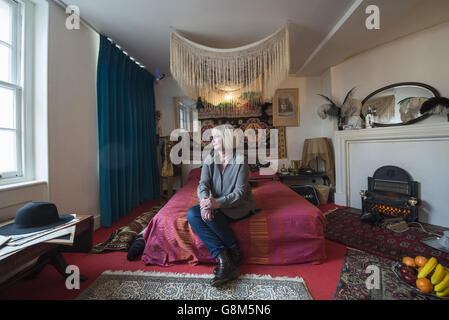 Jimi Hendrix's former girlfriend Kathy Etchingham poses on the musician's bed during the press preview of the new heritage site celebrating Jimi Hendrix at the flat he lived in between 1968 and 1969 on Brook Street, London. Stock Photo