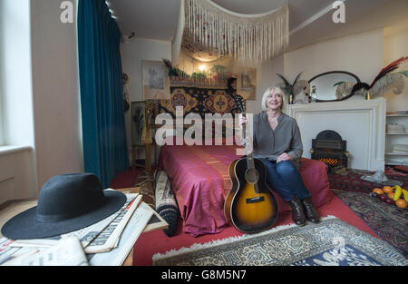 Jimi Hendrix's former girlfriend Kathy Etchingham poses on the musician's bed during the press preview of the new heritage site celebrating Jimi Hendrix at the flat he lived in between 1968 and 1969 on Brook Street, London. Stock Photo