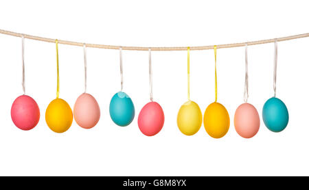Easter eggs hanging on the clothesline isolated on white background Stock Photo