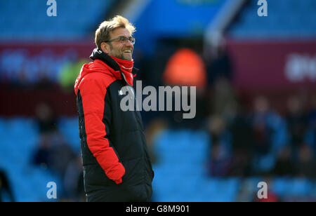 Liverpool manager Jurgen Klopp enjoys watching the Kiss Me Quick Valentine's big tv screen before the Barclays Premier League match at Villa Park, Birmingham. Stock Photo