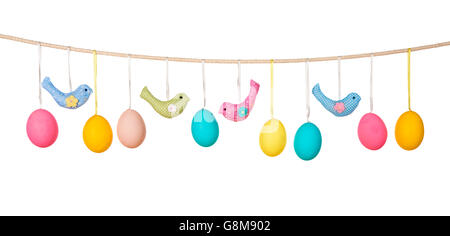 Easter eggs hanging on the clothesline isolated on white background Stock Photo