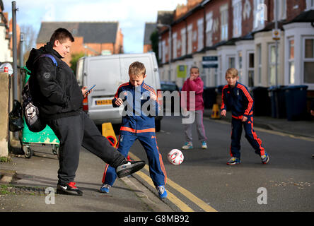 Nottingham Forest v Watford - Emirates FA Cup - Fourth Round - City Ground. Young Nottingham Forest fans playing football in the street prior to the Emirates FA Cup, fourth round match at the City Ground, Nottingham. Stock Photo