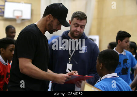 Rio Ferdinand, Founder and Trustee of the Rio Ferdinand Foundation speaks with young people during a visit to one of the Foundation's training and youth programmes. Stock Photo