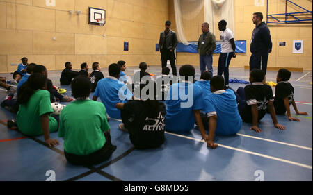 Rio Ferdinand, Founder and Trustee of the Rio Ferdinand Foundation speaks with young people during a visit to one of the Foundation's training and youth programmes. Stock Photo