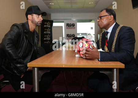 Rio Ferdinand, Founder and Trustee of the Rio Ferdinand Foundation speaks Mayor of Lamberth, Cllr Donatus Anyanwu during a visit to the Foundation's training and youth programmes at the Kia Oval, London. Stock Photo