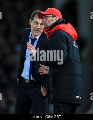 West Ham United manager Slaven Bilic (left) and Liverpool manager Jurgen Klopp during the Emirates FA Cup, fourth round replay match at Upton Park, London. Stock Photo