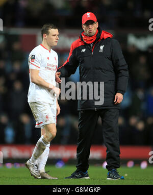 West Ham United v Liverpool - Emirates FA Cup - Fourth Round Replay - Upton Park. Liverpool manager Jurgen Klopp consoles Brad Smith following the Emirates FA Cup, fourth round replay match at Upton Park, London. Stock Photo