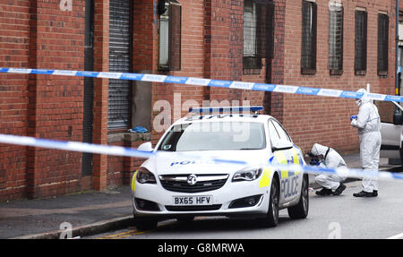 Man shot dead in warehouse robbery bid Stock Photo