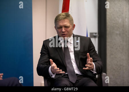 Slovakian Prime Minister Robert Fico, left, speaks with a police ...