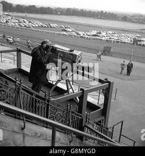 Horse Racing - Sandown Park Racecourse. Cameraman at work at Sandown Park Racecourse. Stock Photo