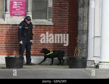 Garda sniffer dogs patrol the area around Our of Lourdes Church in Dublin before the funeral of Eddie Hutch senior who was shot dead in the north inner city last week. Stock Photo