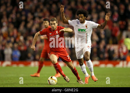 Liverpool v FC Augsburg - UEFA Europa League - Round of 32 - Second Leg - Anfield. Liverpool's Jordan henderson and Augsburg's Caiuby (right) battle for the ball during the UEFA Europa League match at Anfield, Liverpool. Stock Photo