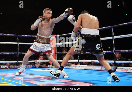 Carl Frampton (left) and Scott Quigg during their IBF & WBA World Super-Bantamweight Championship bout at Manchester Arena. Stock Photo