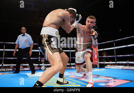 Carl Frampton (right) and Scott Quigg during their IBF & WBA World Super-Bantamweight Championship bout at Manchester Arena. Stock Photo