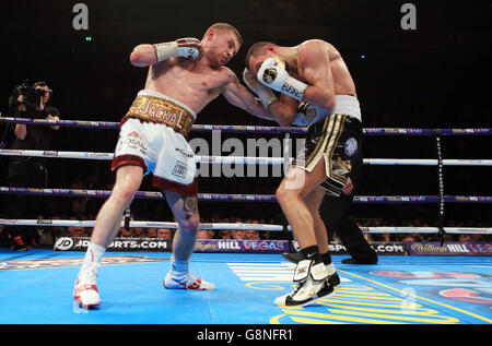 Carl Frampton (left) and Scott Quigg during their IBF & WBA World Super-Bantamweight Championship bout at Manchester Arena. Stock Photo