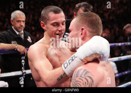 Scott Quigg (left) and Carl Frampton embrace after their IBF & WBA World Super-Bantamweight Championship bout at Manchester Arena. Stock Photo