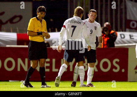 England captain David Beckham attempts to control Wayne Rooney after he is shown the yellow card for a challenge on Northern Ireland's Keith Gillespie Stock Photo