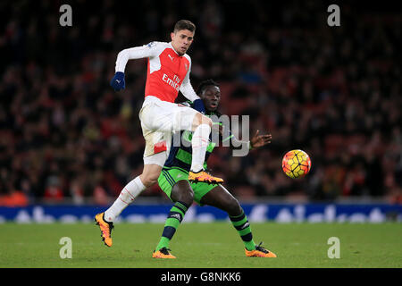Arsenal's Gabriel Paulista and Swansea City's Bafetimbi Gomis (right) battle for the ball during the Barclays Premier League match at the Emirates Stadium, London. Stock Photo