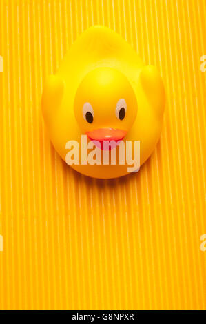 yellow plastic duck toy on yellow background Stock Photo