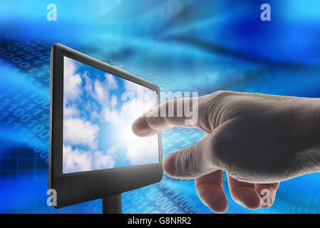man hand touching a screen with clouds Stock Photo