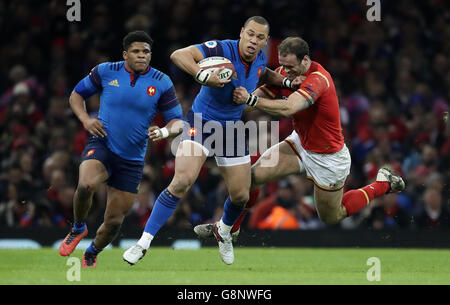 France's Gael Fickou is tackled by Wales' Jamie Roberts during the 2016 RBS Six Nations match at the Principality Stadium, Cardiff. Stock Photo
