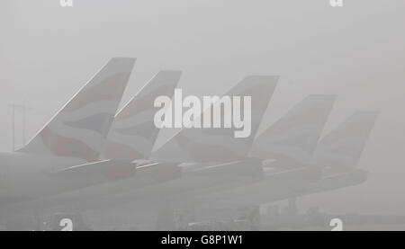 British Airways planes on the tarmac on a foggy morning at Heathrow Airport in London. Stock Photo