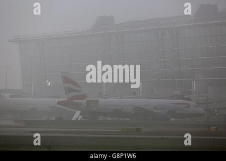 British Airways planes on the tarmac on a foggy morning at Heathrow Airport in London. Stock Photo