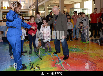 Apollo astronaut Buzz Aldrin joins children in educational activities on a giant map of mars during a visit to the Science Museum, London. Stock Photo