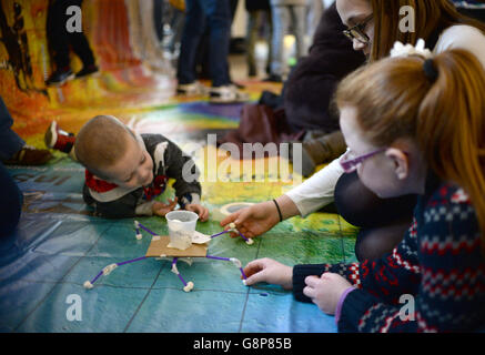 Children make Mars landing modules as Apollo astronaut Buzz Aldrin joins children in educational activities on a giant map of mars during a visit to the Science Museum, London. Stock Photo