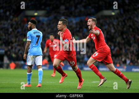 Liverpool's Philippe Coutinho (centre) celebrates scoring their first goal of the game during the Capital One Cup final at Wembley Stadium, London. Stock Photo